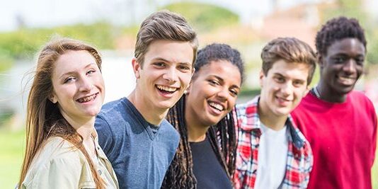 A group of young people smiling for the camera.