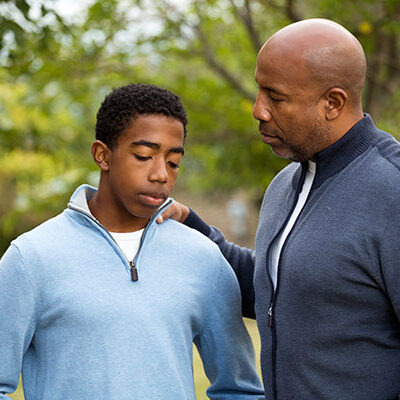 A man and boy standing next to each other.