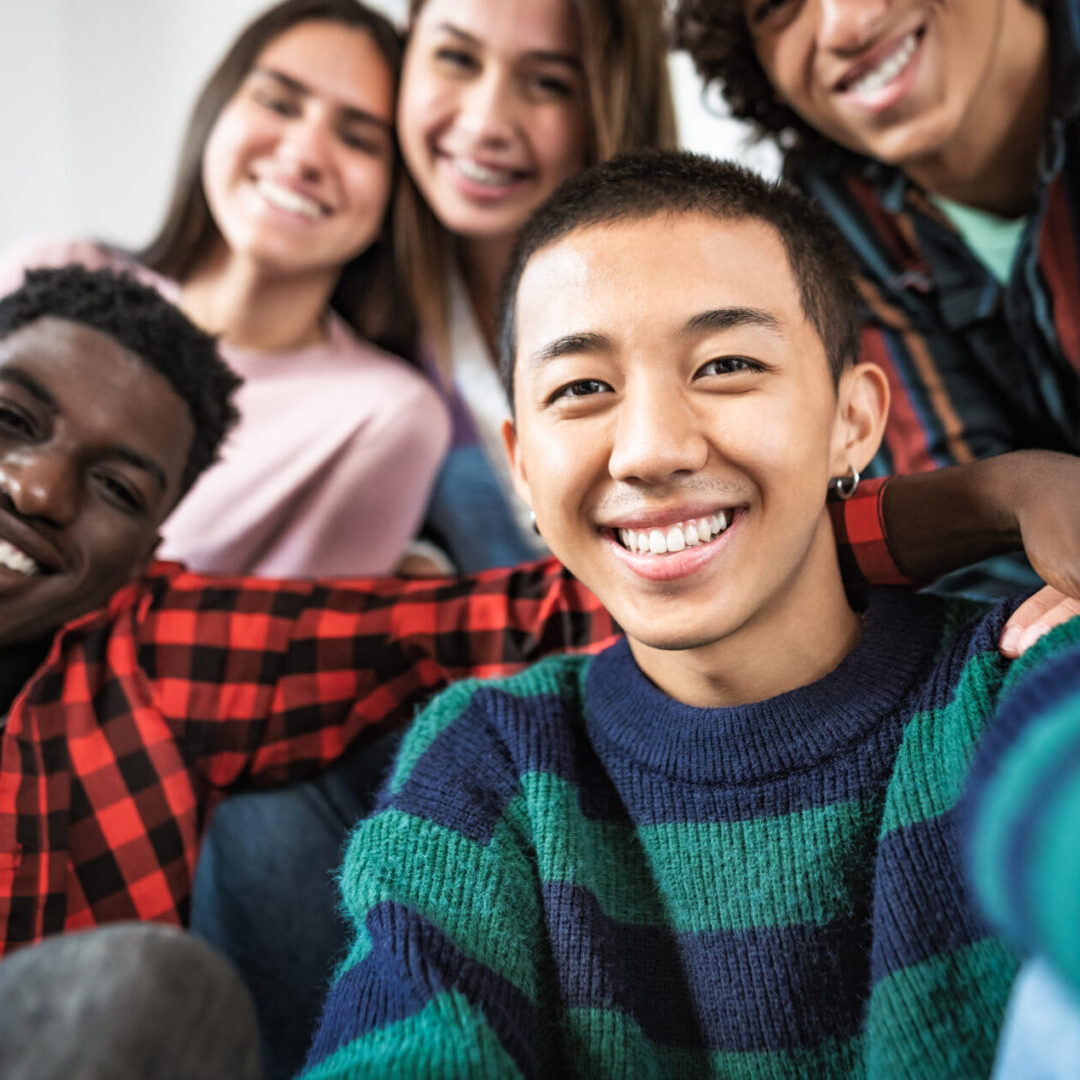 Young multiracial friends taking selfie together A group of young people posing for the camera.